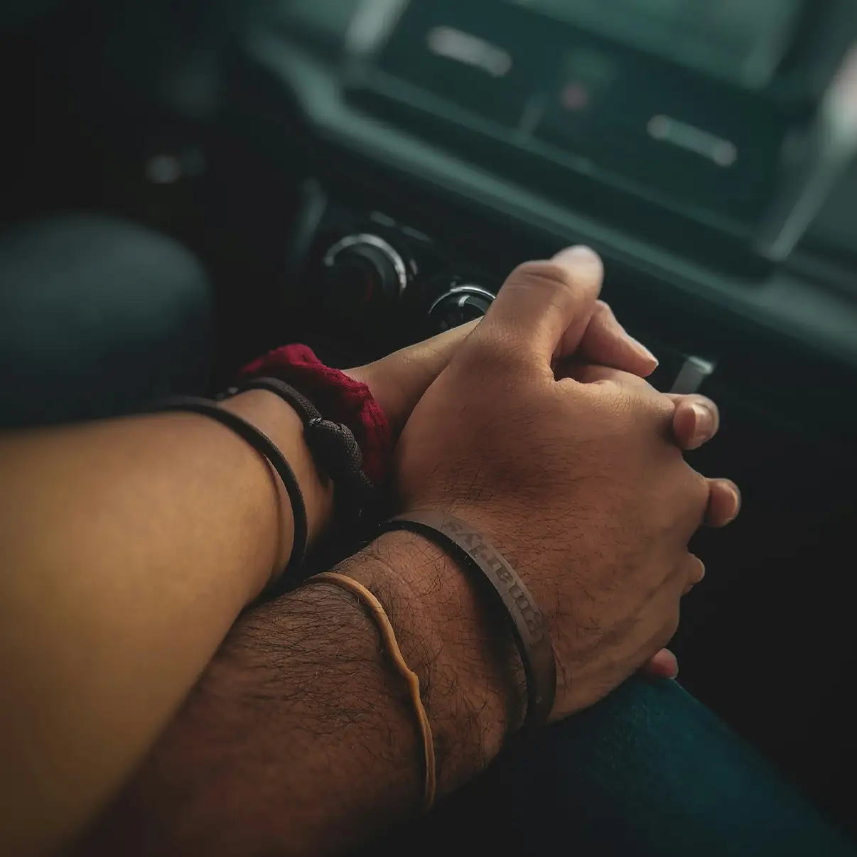 couple dp hand shaking in car